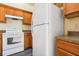 White appliances and light wood cabinets are featured in this kitchen at 1714 Blossom W Cir, Lakeland, FL 33805