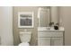 Simple bathroom with white vanity, toilet and shower at 2033 Lasso Loop, Eagle Lake, FL 33839