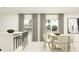 Kitchen and dining area with modern light wood furniture at 2033 Lasso Loop, Eagle Lake, FL 33839