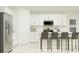 Modern kitchen with white cabinets, stainless steel appliances and island at 2033 Lasso Loop, Eagle Lake, FL 33839