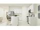 Modern kitchen with white cabinets, stainless steel appliances and island at 2033 Lasso Loop, Eagle Lake, FL 33839