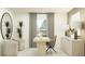 Bright home office with wood desk, two chairs and large mirror at 2033 Lasso Loop, Eagle Lake, FL 33839