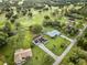 Aerial view of house and neighborhood near golf course at 7491 Limonia Dr, Indian Lake Estates, FL 33855