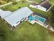 Aerial view showcasing home, pool, and backyard at 7491 Limonia Dr, Indian Lake Estates, FL 33855