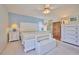 Main bedroom with white furniture and en-suite bathroom access at 7491 Limonia Dr, Indian Lake Estates, FL 33855