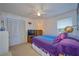 Bedroom with white built-in closet and purple bedding at 7491 Limonia Dr, Indian Lake Estates, FL 33855
