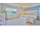 Spacious bedroom with a large bed, dresser, and view of the backyard at 7491 Limonia Dr, Indian Lake Estates, FL 33855