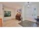 Inviting entryway with tiled floor, white door, and artwork at 7491 Limonia Dr, Indian Lake Estates, FL 33855