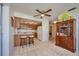 Kitchen features wood cabinets, breakfast bar, and access to living room at 7491 Limonia Dr, Indian Lake Estates, FL 33855