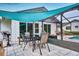 Outdoor patio with dining table and grill at 7491 Limonia Dr, Indian Lake Estates, FL 33855