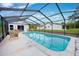 Inviting pool area with screened enclosure at 7491 Limonia Dr, Indian Lake Estates, FL 33855