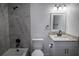 Updated bathroom with gray marble tile, granite vanity, and modern fixtures at 3733 Hill St, Lakeland, FL 33812