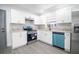 Modern kitchen with white shaker cabinets, granite countertops, and stainless steel appliances at 3733 Hill St, Lakeland, FL 33812