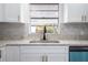 Modern kitchen with white shaker cabinets, granite countertops, and a black faucet at 3733 Hill St, Lakeland, FL 33812
