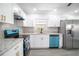 Modern kitchen with white shaker cabinets, granite countertops, and stainless steel appliances at 3733 Hill St, Lakeland, FL 33812