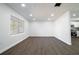 Bright and airy living room featuring new laminate flooring and recessed lighting at 3733 Hill St, Lakeland, FL 33812