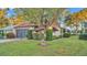 House with a tree in front, showcasing the side view of the home and landscaping at 439 San Jose Dr, Winter Haven, FL 33884