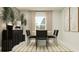 Modern farmhouse dining room with black chairs and a round table at 4128 Singing Mockingbird Blvd, Bartow, FL 33830