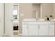 Modern bathroom with white vanity, soaking tub, and large window at 760 Terrapin Dr, Debary, FL 32713