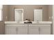 Modern bathroom with double vanity and a large mirror at 760 Terrapin Dr, Debary, FL 32713
