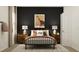 Bedroom with a metal bed frame, wooden nightstands, and dark walls at 760 Terrapin Dr, Debary, FL 32713