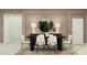 Elegant dining room featuring a black table, white chairs, and a statement mirror at 760 Terrapin Dr, Debary, FL 32713