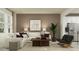 Spacious living room with L-shaped sofa, coffee table, and large windows at 760 Terrapin Dr, Debary, FL 32713