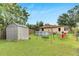 Spacious backyard with shed, above ground pool, and playset at 1375 6 Iron Dr, Lakeland, FL 33801