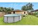 Relaxing backyard oasis with above ground pool and patio at 1375 6 Iron Dr, Lakeland, FL 33801