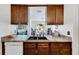Kitchen with double sink and dishwasher, open to dining area at 1375 6 Iron Dr, Lakeland, FL 33801