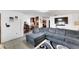 Spacious living room featuring a sectional sofa and large TV at 1375 6 Iron Dr, Lakeland, FL 33801