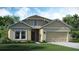 One-story house featuring a two-car garage and landscaped front yard at 4226 Nightcaps Way, Kissimmee, FL 34746