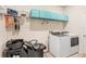 Laundry room with washer, dryer, shelving, and a hair washing station at 1125 Michelangelo Ln, Winter Haven, FL 33884