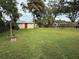 Large backyard with a shed and open grassy area at 303 W Valencia St, Lakeland, FL 33805