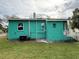 Teal house exterior with a yard and AC unit at 303 W Valencia St, Lakeland, FL 33805