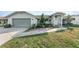 House exterior with green siding, attached garage, and a grassy yard at 918 Hillgrove Ln, Auburndale, FL 33823