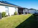 Spacious backyard with grassy lawn, pergola, and solar panels at 6855 Mossy Oak Ln, Lakeland, FL 33810