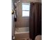 Clean bathroom with a shower/tub combo, gray tile, and gray curtain at 6855 Mossy Oak Ln, Lakeland, FL 33810
