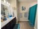 Modern bathroom with teal accents, walk-in shower, and updated vanity at 6855 Mossy Oak Ln, Lakeland, FL 33810