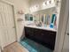 Double vanity bathroom with marble-look countertops and dark brown cabinets at 6855 Mossy Oak Ln, Lakeland, FL 33810