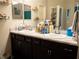 Double vanity bathroom with modern dark brown cabinets and a marble countertop at 6855 Mossy Oak Ln, Lakeland, FL 33810