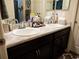 Double vanity bathroom with marble-look countertops and dark brown cabinets at 6855 Mossy Oak Ln, Lakeland, FL 33810