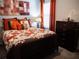 Charming bedroom with a full-size bed, dresser, and decorative accents at 6855 Mossy Oak Ln, Lakeland, FL 33810