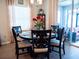 Elegant dining room with a round table, six chairs, and access to a patio at 6855 Mossy Oak Ln, Lakeland, FL 33810