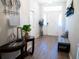 Bright and airy entryway with wood-look floors, bench, and decorative accents at 6855 Mossy Oak Ln, Lakeland, FL 33810