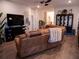 Spacious living room featuring a brown leather sectional sofa and built-in fireplace at 6855 Mossy Oak Ln, Lakeland, FL 33810