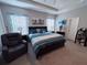 Large main bedroom with plush carpeting, ample natural light, and room for seating at 6855 Mossy Oak Ln, Lakeland, FL 33810