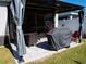 Covered patio with pavers, seating, and a grill at 6855 Mossy Oak Ln, Lakeland, FL 33810