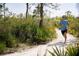 Person jogging on a scenic community trail at 3007 Mirage Pl, Saint Cloud, FL 34771