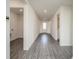 Bright hallway with wood-look floors and access to laundry and bathroom at 14 Tuna Ln, Poinciana, FL 34759